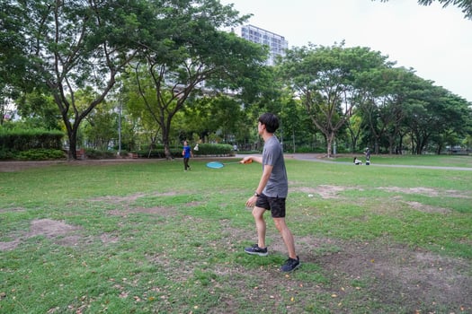 Young people play badminton and repair diligently in the park area. photo