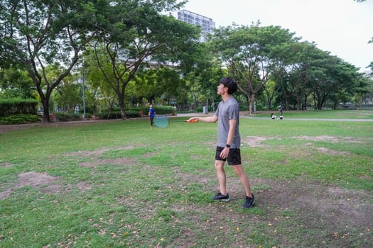 Young people play badminton and repair diligently in the park area. photo