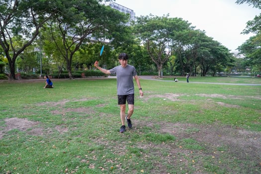 Young people play badminton and repair diligently in the park area. photo