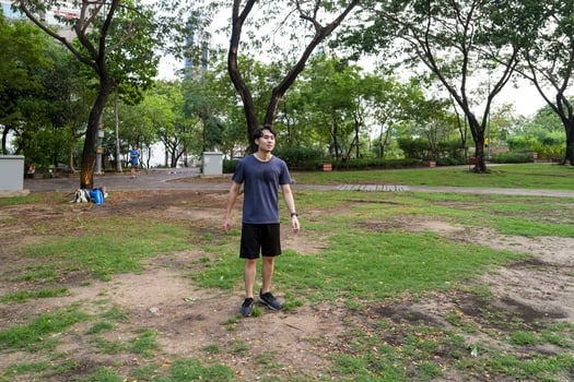 Male soccer players practice using the ball in the park field diligently and happily. photo