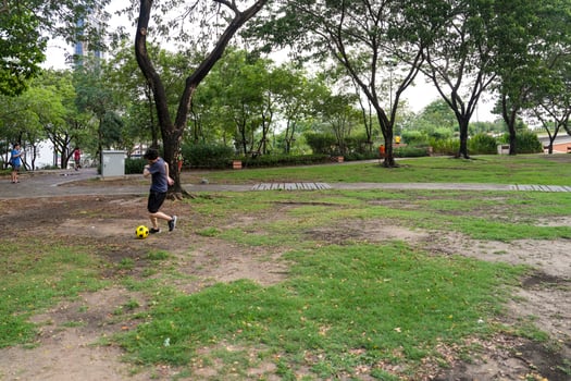 Male soccer players practice using the ball in the park field diligently and happily. photo