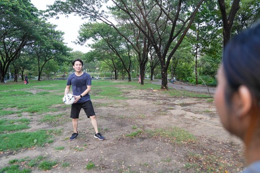 Male and female soccer players practice using the ball in the park field diligently and happily. photo