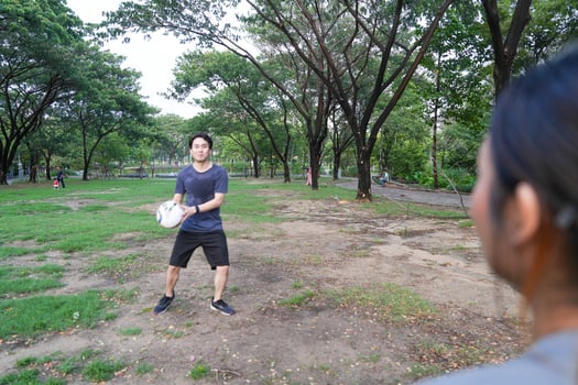 Male and female soccer players practice using the ball in the park field diligently and happily. photo