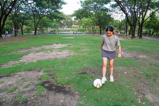 female soccer players practice using the ball in the park field diligently and happily. photo