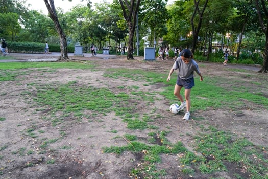 Male and female soccer players practice using the ball in the park field diligently and happily. photo