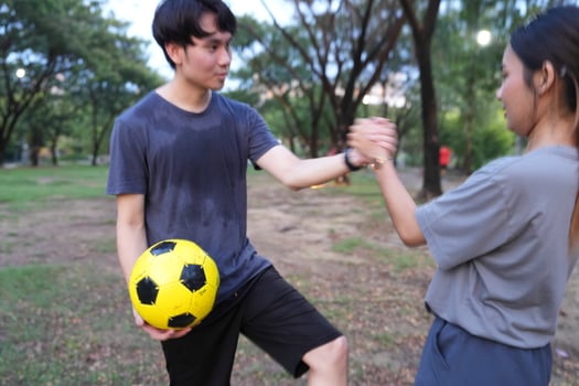 Male and female soccer players practice using the ball in the park field diligently and happily. photo