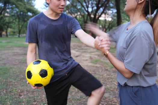 Male and female soccer players practice using the ball in the park field diligently and happily. photo