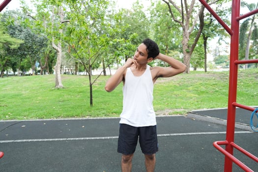 Asian man practicing gymnastics doing gymnastics bar and hoop exercises and stretching and resting for sports. photo