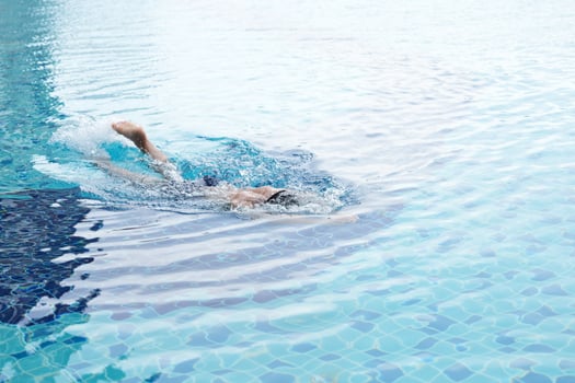 Asian men practicing swimming and preparing to play water polo and stretching and resting for water sports. photo