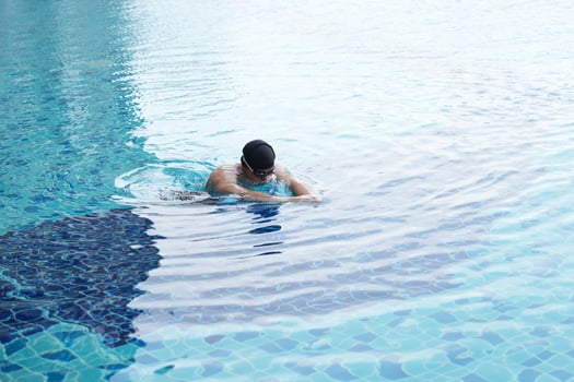 Asian men practicing swimming and preparing to play water polo and stretching and resting for water sports. photo
