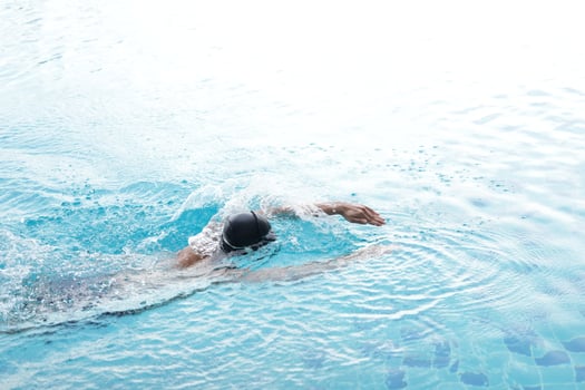 Asian men practicing swimming and preparing to play water polo and stretching and resting for water sports. photo