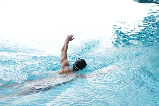 Asian men practicing swimming and preparing to play water polo and stretching and resting for water sports. photo