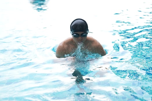 Asian men practicing swimming and preparing to play water polo and stretching and resting for water sports. photo