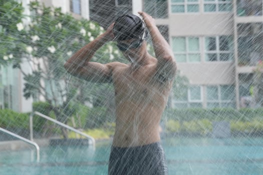 Asian men practicing swimming and preparing to play water polo and stretching and resting for water sports. photo