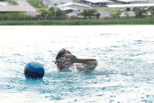 Asian men practicing swimming and preparing to play water polo and stretching and resting for water sports. photo