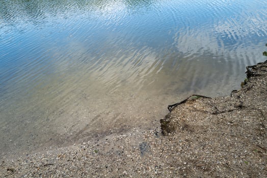 sandy pebbly shore on inland lake photo
