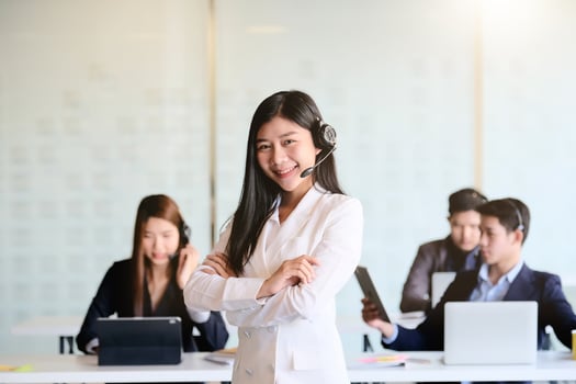 Portrait of young friendly operator woman agent with headsets working photo