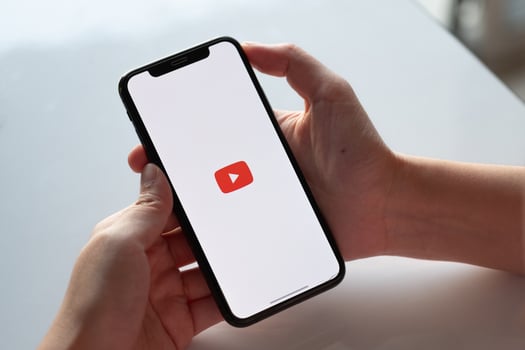 CHIANG MAI, THAILAND - NOV.17 ,2019. Woman holding iPhone Xs with Youtube apps on screen. photo