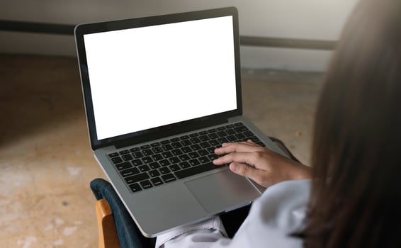 young woman working with laptop computer at home, empty screen display photo