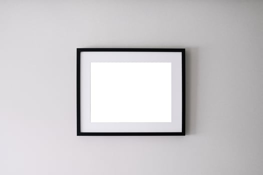 Blank frame on a white wall background photo