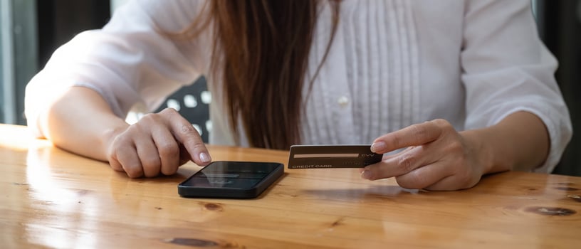 Hands holding credit card and using mobile phone. Online shopping. photo