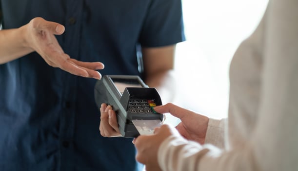 Customer using credit card for payment to owner at cafe restaurant photo