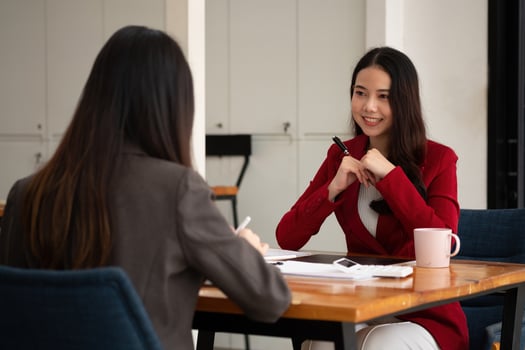Young Asian businesswoman work together to analysis from work at the office photo