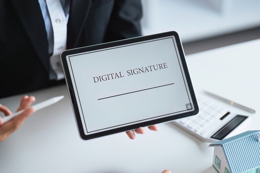 Close-up of female hand signing e-document with on tablet. Electronic signature and modern technologies concept photo