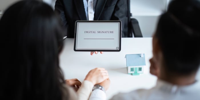 Close-up of female hand signing e-document with on tablet. Electronic signature and modern technologies concept photo