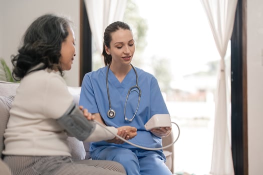 Nurse using digital tonometer check blood pressure for to patient elderly old female at hospital in elderly care. health care concept photo