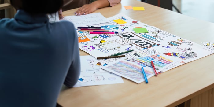 Close up ux developer and ui designer use augmented reality brainstorming about mobile app interface wireframe design on desk at modern office. creative digital development agency photo