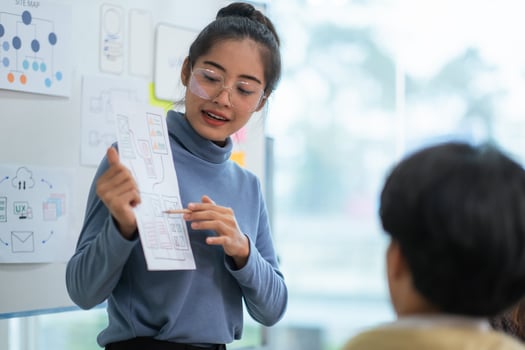 Ux developer and ui designer use augmented reality brainstorming about mobile app interface wireframe design on desk at modern office. creative digital development agency photo