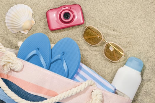 Summer Concept. Beach Accessories on Sandy Background photo