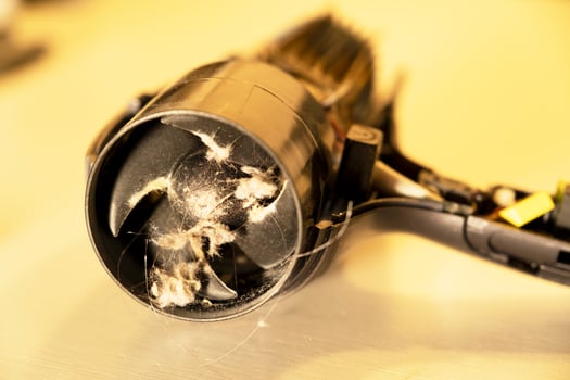broken, burnt hair dryer. the hair dryer burned out due to dust and hair. photo