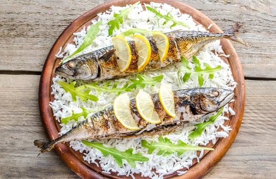 Grilled mackerel with basmati rice and fresh arugula photo