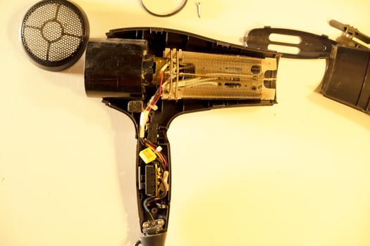 broken, burnt hair dryer. the hair dryer burned out due to dust and hair. photo