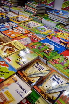 New Delhi, India, February 17 2024 - Variety of Books on shelf inside a book-stall at Delhi International Book Fair, Selection of books on display in Annual Book Fair at Bharat Mandapam complex photo