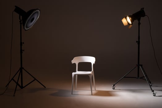 Photo studio with lighting equipment. light scheme and chair. The concept of selection and casting. Job recruitment advertisement.
