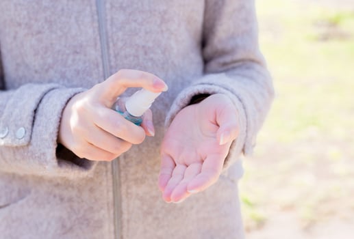 Woman's hands press a bottle with a disinfectant to her hands on the street. Macro shot and macro shot, Selective focus, Prevention by covid 19, Bacteria, healthcare concept photo
