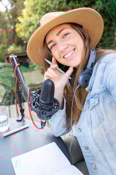 Selfie portrait happy smiling young woman with headphones recording podcast. photo