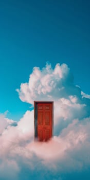 Mysterious Red Door Floating Amongst Clouds in a Clear Blue Sky photo