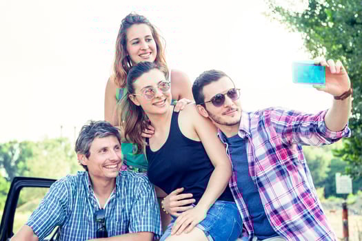 Happy group of young people takes a selfie photo
