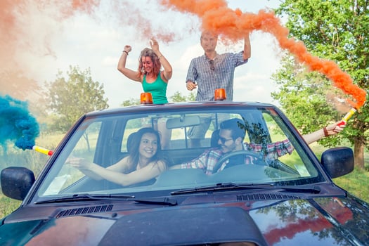 Group of young guys have fun with colored smoke trails photo
