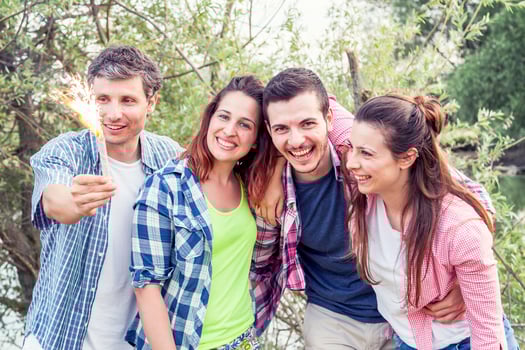 group of friends having fun outdoor on a summer sunset photo