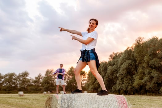 young millennial couple are doing synchronized gymnastics on the sheaves photo