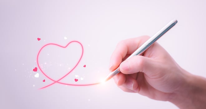 A shiny red heart floats on the man's hand. Love ideas for Valentine's Day with sweet and romantic moments. photo
