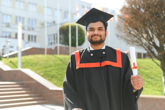 education, graduation and people concept - happy Indian Male graduate student photo