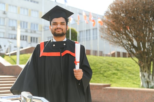 Portrait of happy man, graduation or student in university campus photo