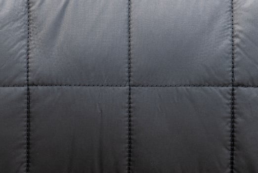 Texture black leather sofa has square seams. photo