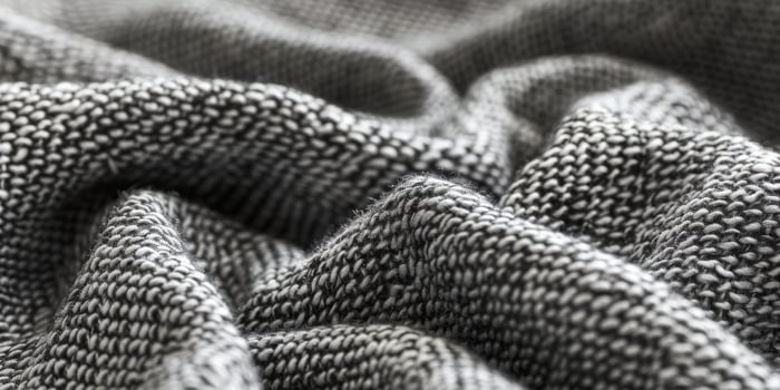 A close up of a gray and white knit fabric photo